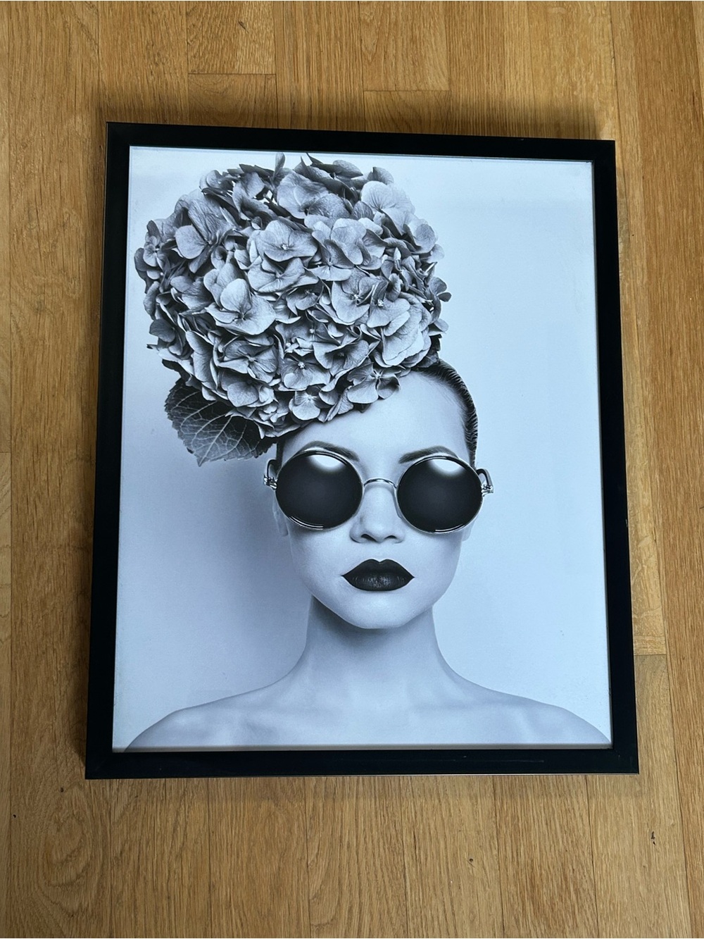 Black & white framed art print of a woman with a large hydrangea 17x21in